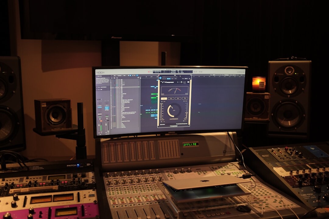 Professional recording studio with large mixing console and broadcast equipment
